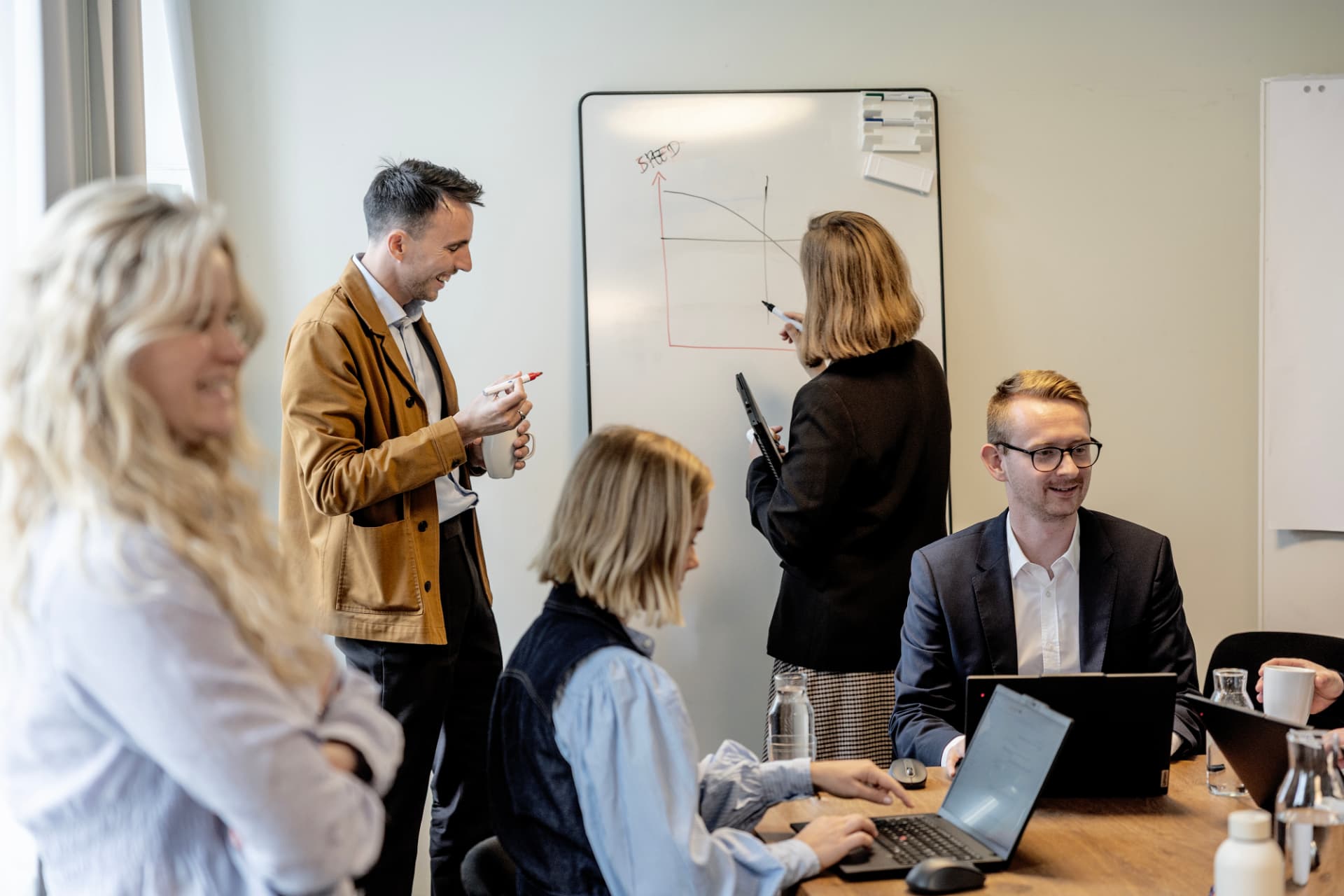 Team collaborating at a desk in a bright Nordic office